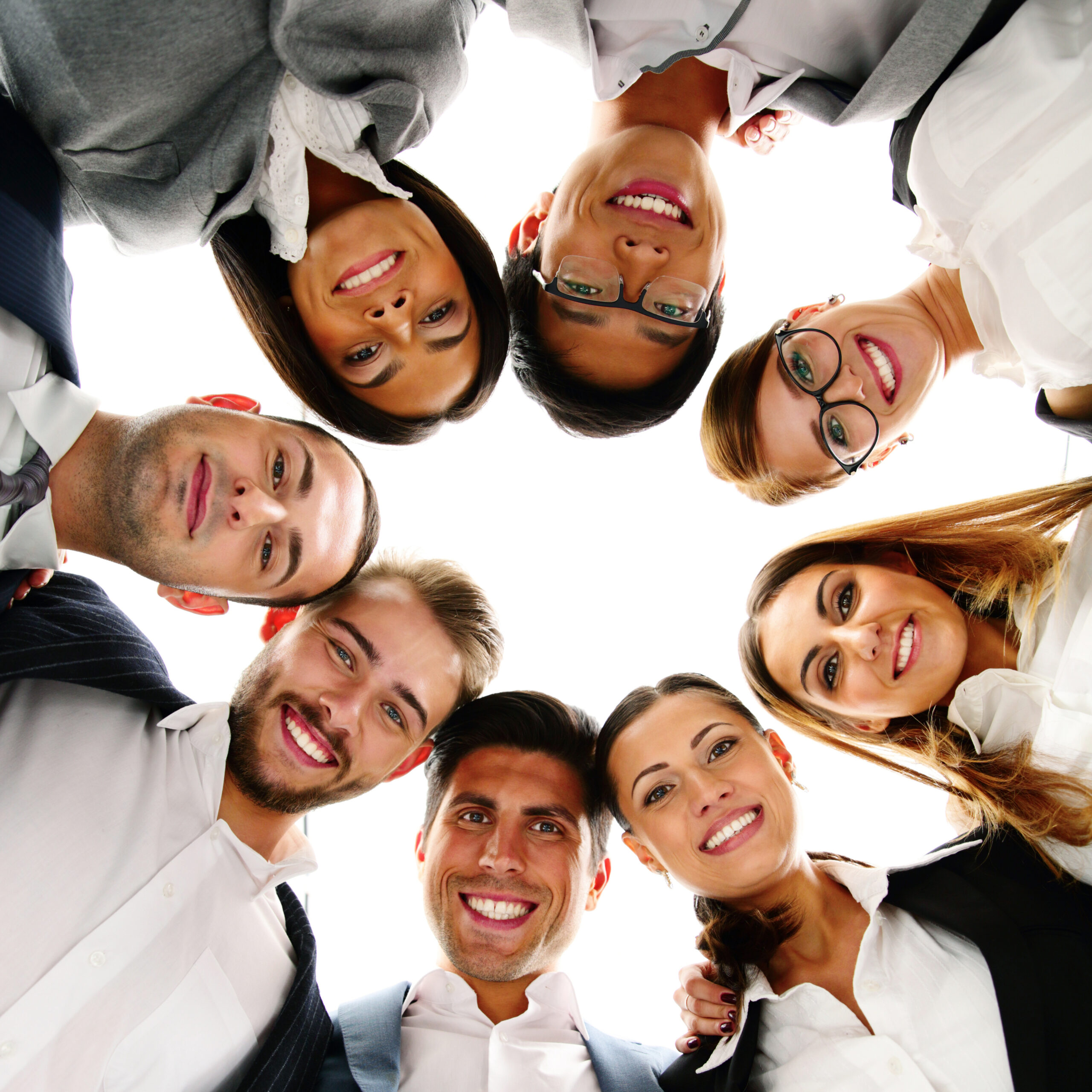 Group of business people in a circle looking down